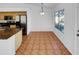 Bright dining area featuring tile flooring, a modern light fixture, and a window with outdoor views at 12914 W Wilshire Dr, Avondale, AZ 85392
