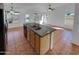 Modern kitchen island featuring a granite countertop, sink, and ample space, ideal for food preparation at 12914 W Wilshire Dr, Avondale, AZ 85392