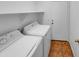 Laundry room features laundry machines, shelf and tile floor at 12914 W Wilshire Dr, Avondale, AZ 85392