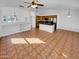 Open-concept living room and kitchen with neutral walls, tile flooring, and modern lighting fixtures at 12914 W Wilshire Dr, Avondale, AZ 85392