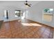 Bright living room with tile flooring, multiple windows, and a glass door providing access to the outdoors at 12914 W Wilshire Dr, Avondale, AZ 85392