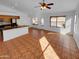 Open-concept living room and kitchen featuring tile flooring, natural light, and modern appliances at 12914 W Wilshire Dr, Avondale, AZ 85392