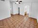 Spacious living room featuring tile flooring, neutral walls, and a ceiling fan for added comfort at 12914 W Wilshire Dr, Avondale, AZ 85392