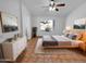 Main bedroom featuring ceiling fan, window, and a decorative mirror at 12914 W Wilshire Dr, Avondale, AZ 85392