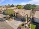 Aerial view of a single-story home with a tile roof, well-manicured landscaping, and a two-car garage at 1313 W Straford Ave, Gilbert, AZ 85233