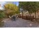Charming backyard patio area, featuring a shade sail, brick pavers, and a trellis at 1313 W Straford Ave, Gilbert, AZ 85233