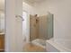 Modern bathroom featuring a glass-enclosed shower and a separate bathtub at 1313 W Straford Ave, Gilbert, AZ 85233