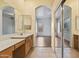 Bathroom with a double sink vanity and an arched entrance leading to the bedroom at 1313 W Straford Ave, Gilbert, AZ 85233