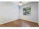 Cozy bedroom with wood floors and a window view of the greenery at 1313 W Straford Ave, Gilbert, AZ 85233