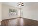 Spacious bedroom with wood floors, ceiling fan, and bright windows at 1313 W Straford Ave, Gilbert, AZ 85233