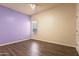 Bedroom with wood floors, ceiling fan and a purple accent wall at 1313 W Straford Ave, Gilbert, AZ 85233