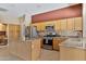 Spacious kitchen featuring stainless steel appliances, granite countertops, a central island, and ample cabinet space at 1313 W Straford Ave, Gilbert, AZ 85233