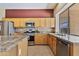 Well-equipped kitchen with granite counters, stainless appliances, tile backsplash and a large window over the sink at 1313 W Straford Ave, Gilbert, AZ 85233
