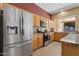 Modern kitchen with stainless steel appliances, granite countertops, and wooden cabinetry, perfect for culinary enthusiasts at 1313 W Straford Ave, Gilbert, AZ 85233