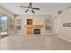 Living room with tile floors, fireplace and ceiling fan at 1313 W Straford Ave, Gilbert, AZ 85233