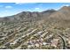 Expansive aerial showcasing the community layout amid desert landscape and mountains under a vibrant blue sky at 13662 E Shaw Butte Dr, Scottsdale, AZ 85259