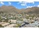 Desert community nestled in the mountains with beautiful homes and desert landscaping under a blue sky at 13662 E Shaw Butte Dr, Scottsdale, AZ 85259