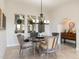 Elegant dining room features a modern chandelier and windows framing the serene exterior view at 13662 E Shaw Butte Dr, Scottsdale, AZ 85259