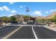 Community entrance gate with an American flag with mountain views in the background at 13662 E Shaw Butte Dr, Scottsdale, AZ 85259