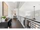 Upper hallway shows dark hardwood floors and a black metal banister at 13662 E Shaw Butte Dr, Scottsdale, AZ 85259