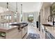 Open kitchen showcases a cooktop island and connects to a cozy seating area with bright light at 13662 E Shaw Butte Dr, Scottsdale, AZ 85259