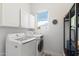 Clean laundry room with LG washer and dryer, storage cabinets, and natural light at 13662 E Shaw Butte Dr, Scottsdale, AZ 85259