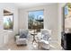 Cozy sitting area with comfortable chairs and a window overlooking a refreshing pool at 13662 E Shaw Butte Dr, Scottsdale, AZ 85259