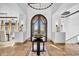 Grand foyer featuring travertine floors, decorative table, and arched wrought iron doorway at 14475 E Cortez Dr, Scottsdale, AZ 85259