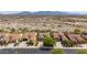 Desert community aerial view showcasing the house with desert landscaping and mountain views in the distance at 15313 S 180Th Ave, Goodyear, AZ 85338