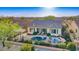Aerial view of the home with a private backyard featuring a pool, patio and barbeque area at 15313 S 180Th Ave, Goodyear, AZ 85338