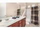 Bathroom featuring a double vanity, white counters, tan walls, tile floor, and a shower-tub combo at 15313 S 180Th Ave, Goodyear, AZ 85338
