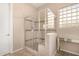 Bathroom with a glass shower enclosure, a glass block window and a mirrored vanity at 15313 S 180Th Ave, Goodyear, AZ 85338