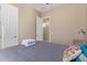 Bedroom featuring a ceiling fan, a window, tan walls, tile floor, and a gray bedspread at 15313 S 180Th Ave, Goodyear, AZ 85338