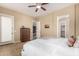 Neutral toned bedroom with tiled floor, a ceiling fan, and comfortable furnishings at 15313 S 180Th Ave, Goodyear, AZ 85338