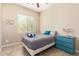 Bedroom featuring tan walls, tile floor, a ceiling fan, a gray bedspread, and a window at 15313 S 180Th Ave, Goodyear, AZ 85338