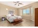 Bright bedroom with a large window, tiled floor, and a comfortable, stylish platform bed at 15313 S 180Th Ave, Goodyear, AZ 85338