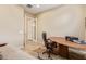Bedroom featuring a wood desk, a leather office chair, and tan walls at 15313 S 180Th Ave, Goodyear, AZ 85338