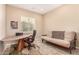 Bedroom featuring a tan futon, wood desk, leather chair, tan walls, and tile floors at 15313 S 180Th Ave, Goodyear, AZ 85338