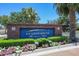 A community sign welcomes residents with beautiful landscaping and a brick surround at 15313 S 180Th Ave, Goodyear, AZ 85338