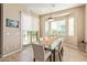 Bright dining area with a glass table and chairs, featuring sliding glass doors to the backyard at 15313 S 180Th Ave, Goodyear, AZ 85338