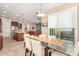 Elegant dining area with glass table and views to kitchen and living room at 15313 S 180Th Ave, Goodyear, AZ 85338