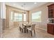 Dining room with tiled floors, bright lighting, and large windows with privacy blinds at 15313 S 180Th Ave, Goodyear, AZ 85338