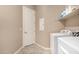 Practical laundry room featuring a white washer and dryer, storage shelf, and neutral wall paint at 15313 S 180Th Ave, Goodyear, AZ 85338