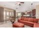 Inviting living space with a comfortable leather sofa and view of the open kitchen at 15313 S 180Th Ave, Goodyear, AZ 85338