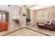 Open-concept living space with tile flooring, opening to the kitchen with modern appliances at 15313 S 180Th Ave, Goodyear, AZ 85338