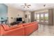 Well-lit living area with a comfortable sofa and sliding doors that open to the pool at 15313 S 180Th Ave, Goodyear, AZ 85338