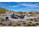 A beautiful outdoor patio offers ample seating, desert landscaping, and a fireplace at 15313 S 180Th Ave, Goodyear, AZ 85338