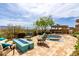 Open patio featuring a gas fire pit with comfortable seating and an outdoor eating area at 15313 S 180Th Ave, Goodyear, AZ 85338