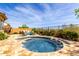 Inviting pool area with stone surround, cozy seating and landscaped desert plants offers a tranquil retreat at 15313 S 180Th Ave, Goodyear, AZ 85338