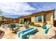 An outdoor entertainment area features a pool, firepit and travertine patio at 15313 S 180Th Ave, Goodyear, AZ 85338
